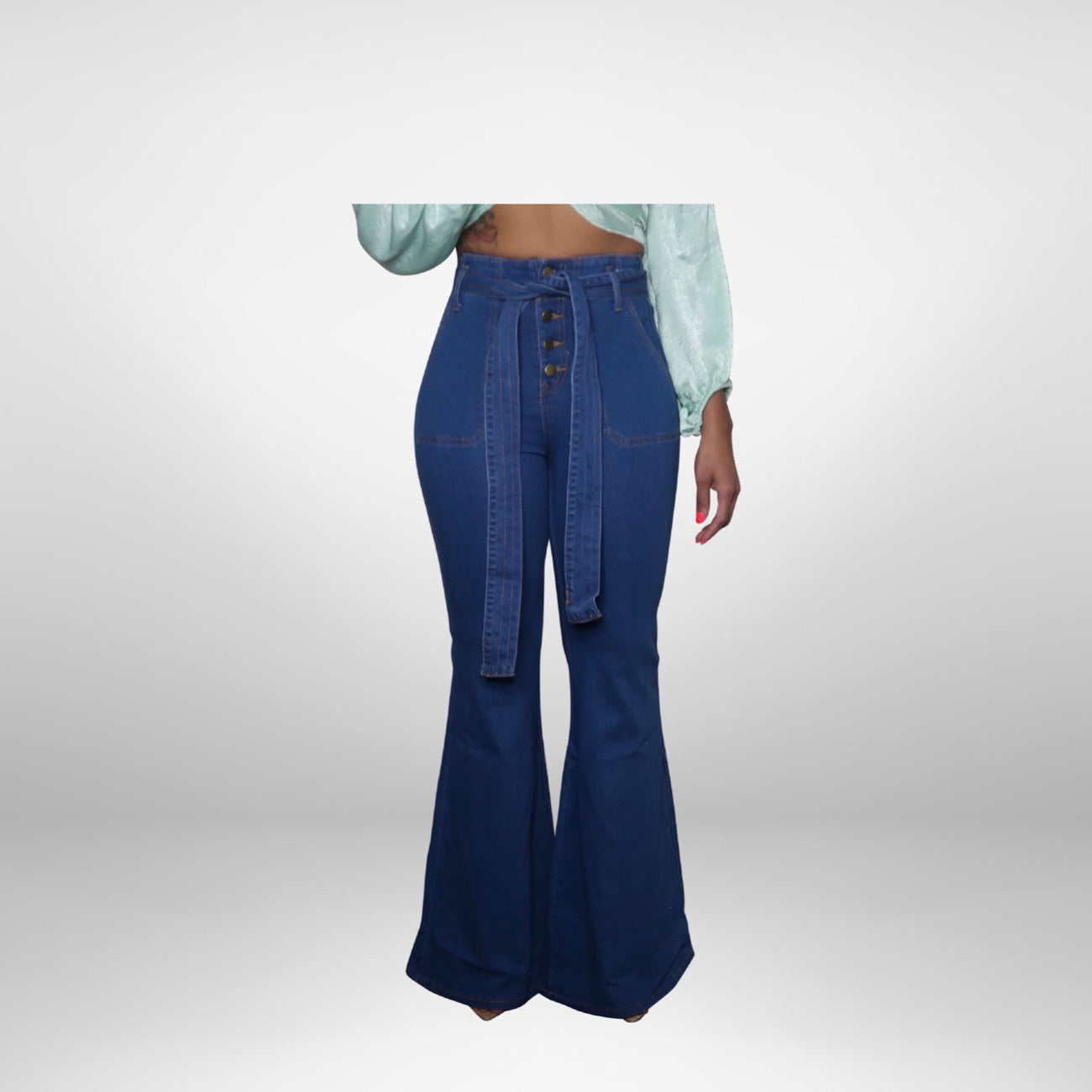 Flirty fit wide leg flare jeans with detachable belt that accentuates the waist. Features front pockets and button detail.