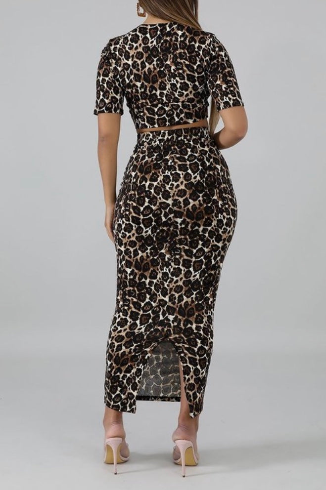 Featuring a body-hugging design with a round neckline, short sleeves, and matching midi skirt, leopard print 