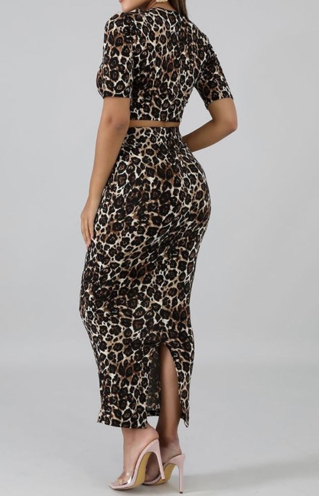 Featuring a body-hugging design with a round neckline, short sleeves, and matching midi skirt, leopard print 